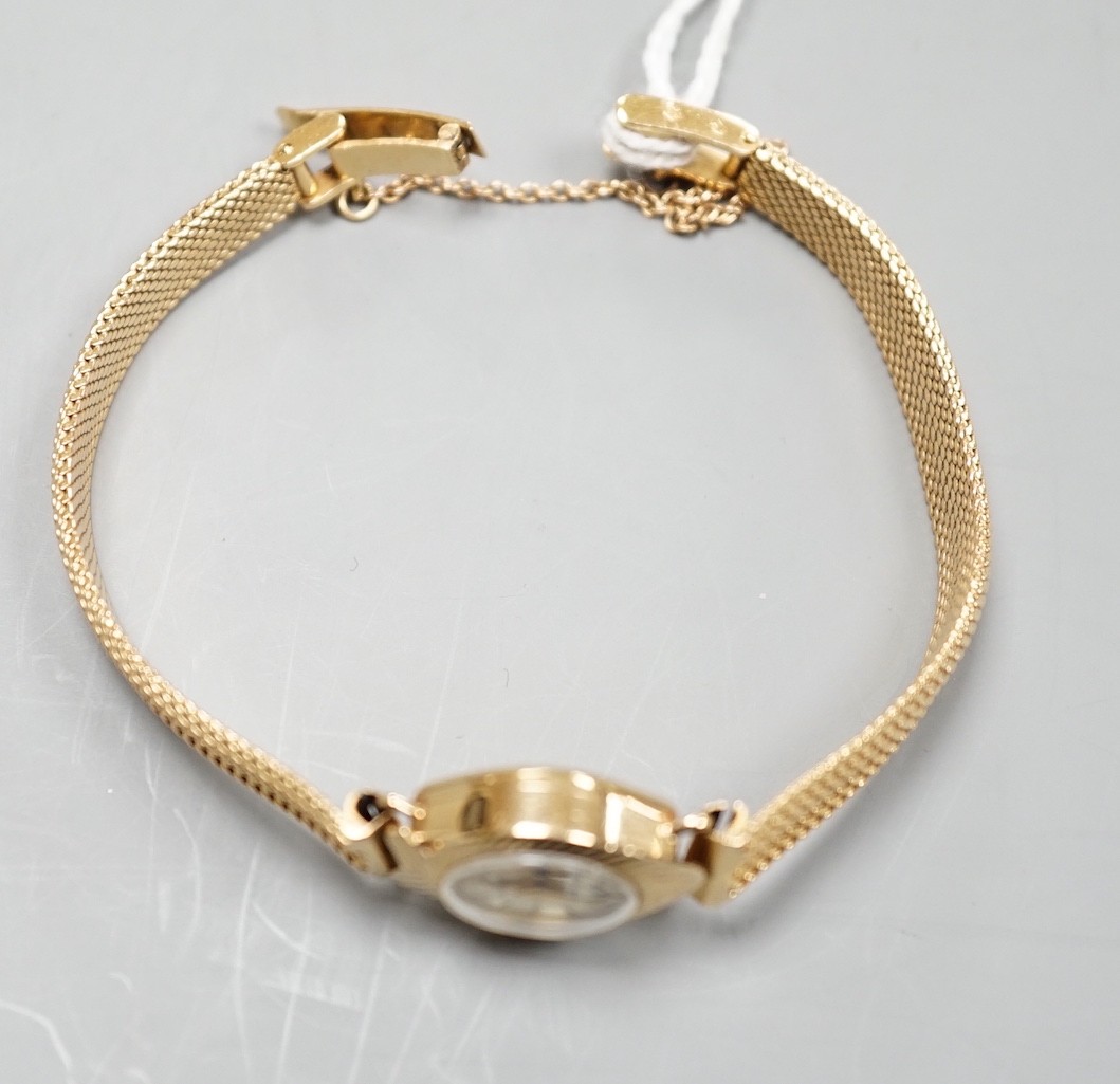 A lady's 9ct gold Accurist manual wind wrist watch, on a continental yellow metal bracelet, gross weight 21.2 grams.